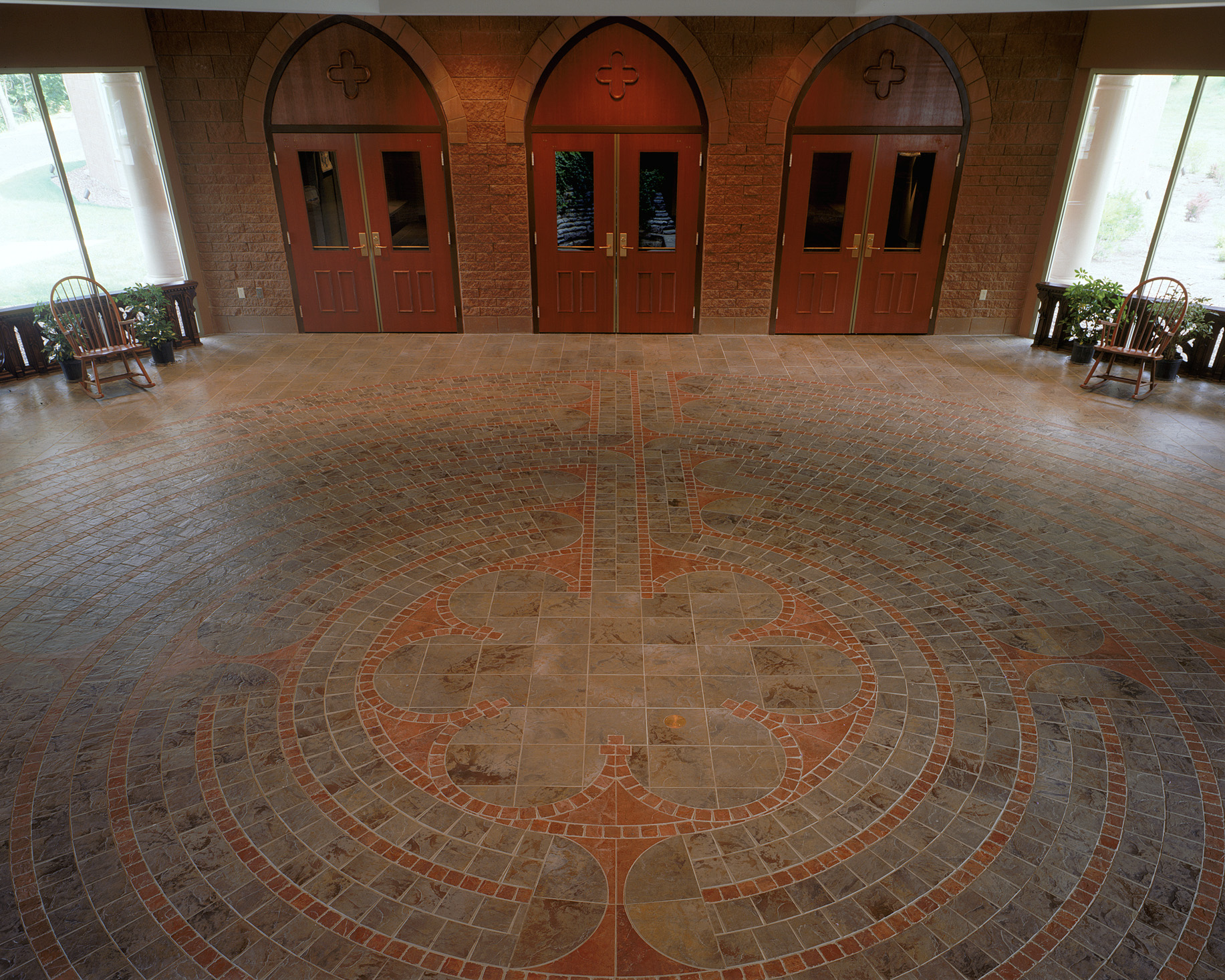 A labyrinth is incorporated into the narthex floor in subtle materials.